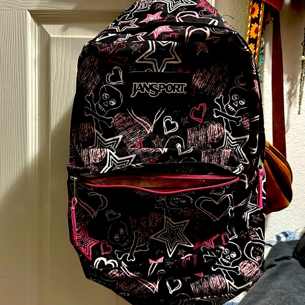 Jansport backpack. With, skulls, stars and hearts, pink and black